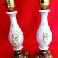 Pair Bisque Porcelain Mid Century Accent Table Lamps Off White w/ Embossed Cherubs/Angels Gold Cast Brass Footed Base Rococo Style Retro